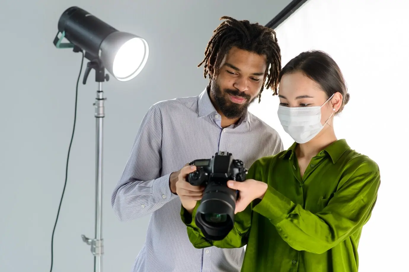People with a camera and a medical mask