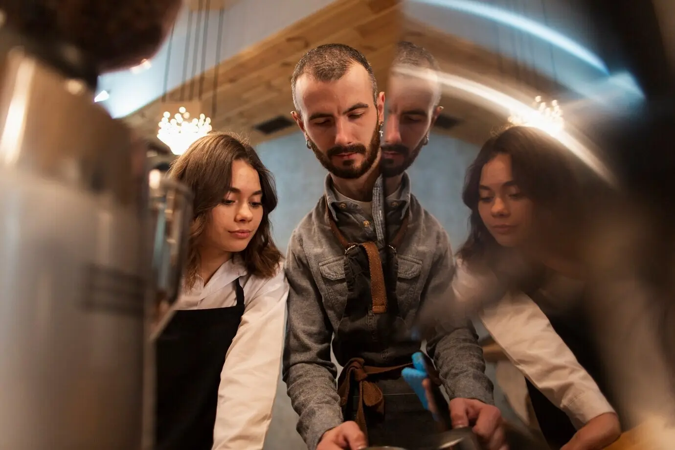 Man and woman in aprons working in a coffee shop