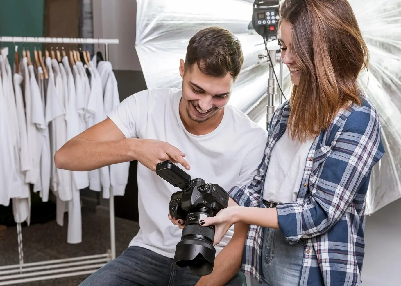 A woman and a man in a professional photography studio.